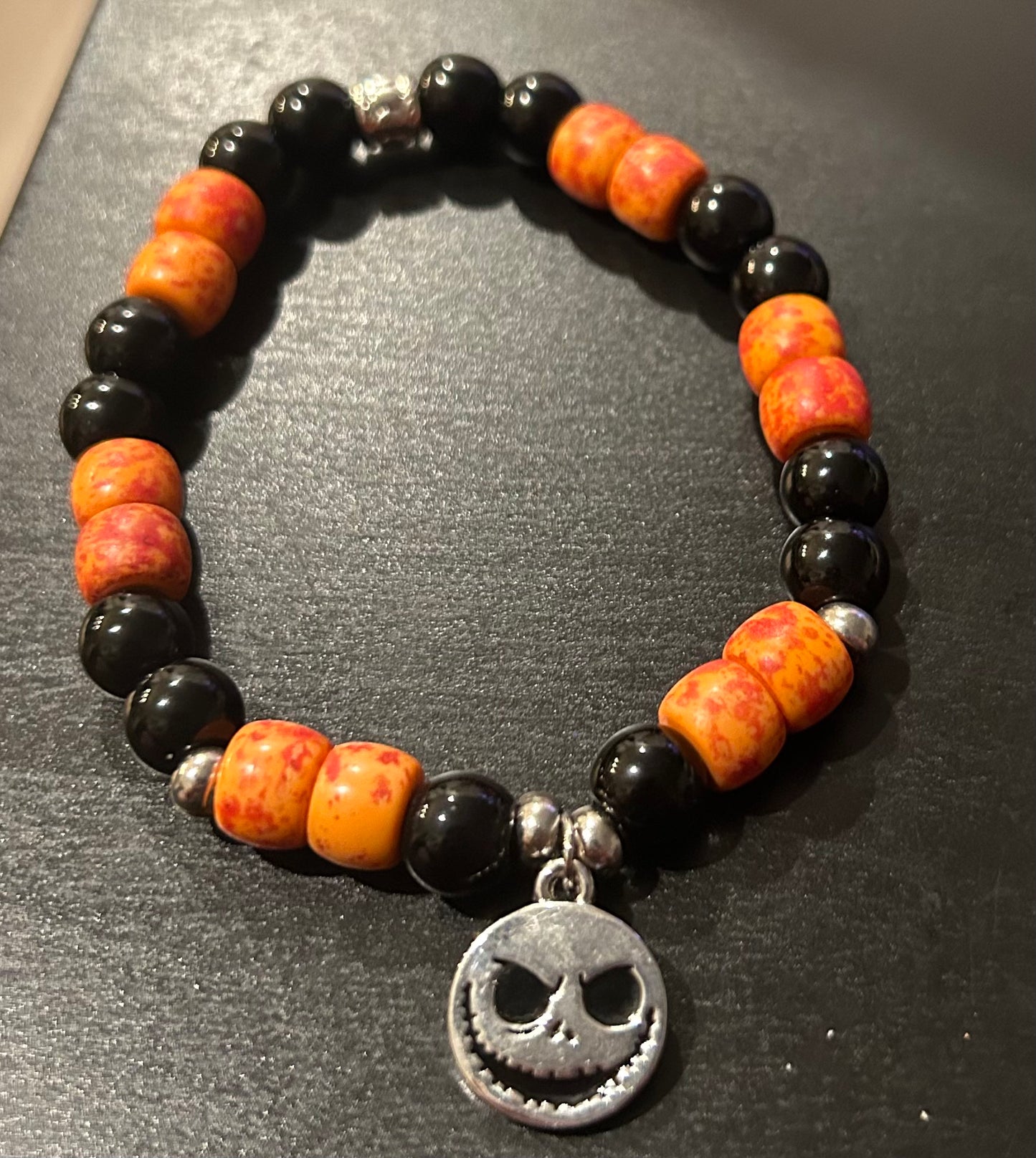 Tangerine orange w/black stones “Jack Skellington” Nightmare Before Cheistmas w/Charm